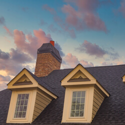 Three Dormers And Two Brick Chimneys